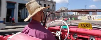 Dirver in a convertible car in Havana